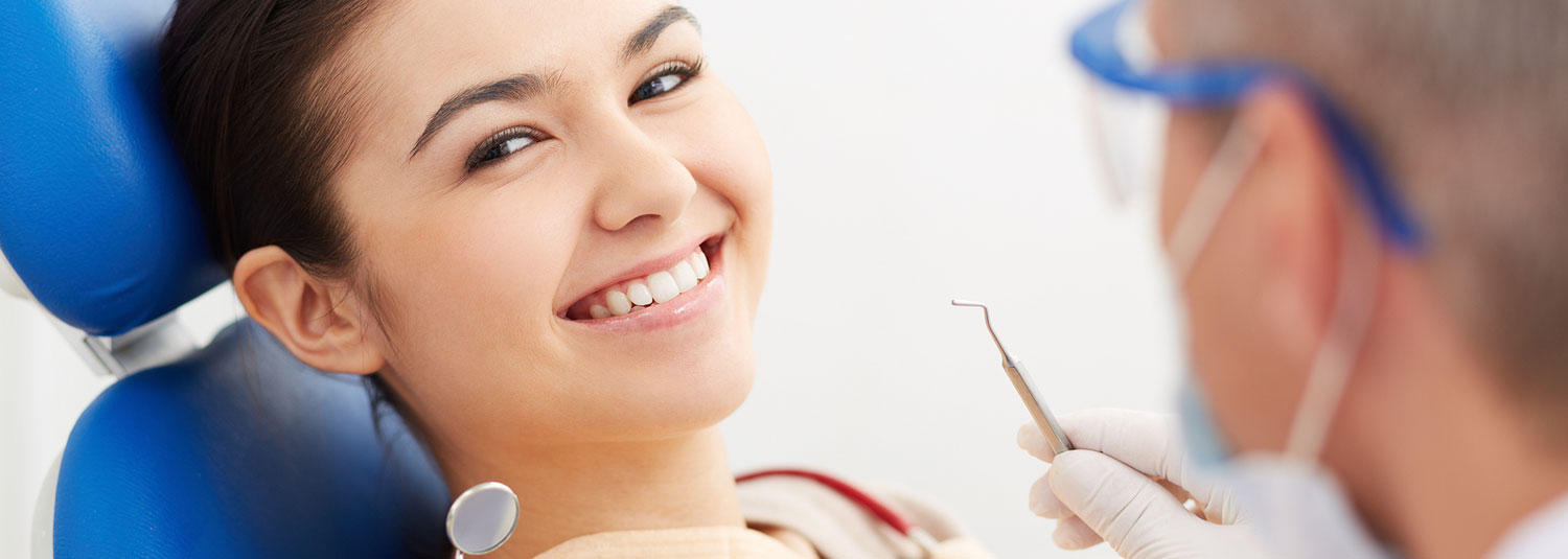 young girl sitting in dental chair