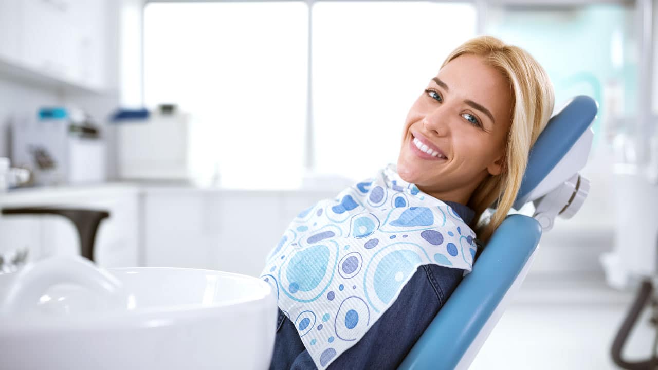 Woman sitting in dental chair at dental office